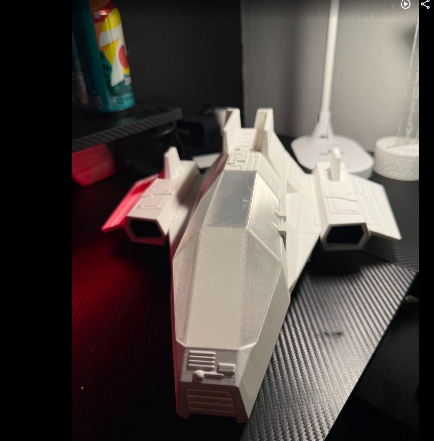 White 3D printed sci-fi fighter starship model with red accents